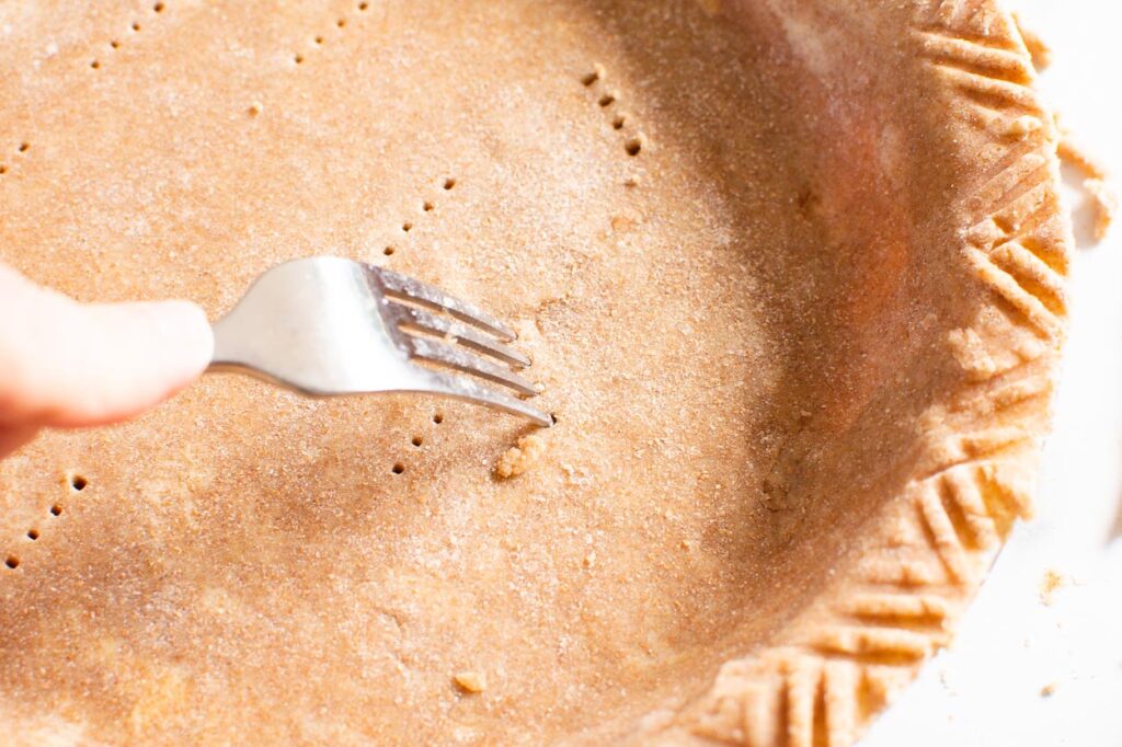 poking pie crust with a fork