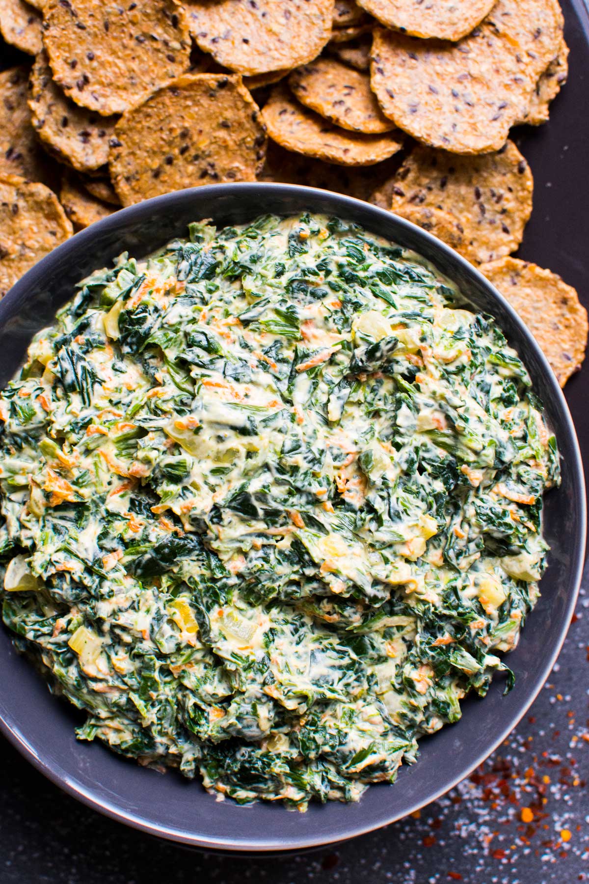 healthy spinach dip with crackers in a bowl for serving