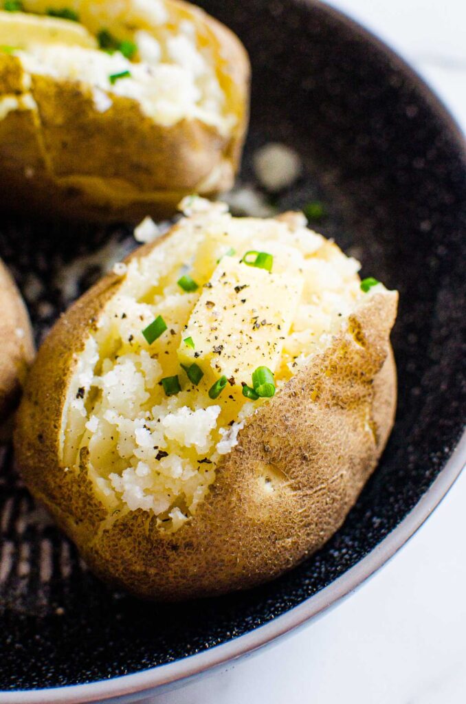 instant pot baked russet potatoes ready to eat with butter and chives