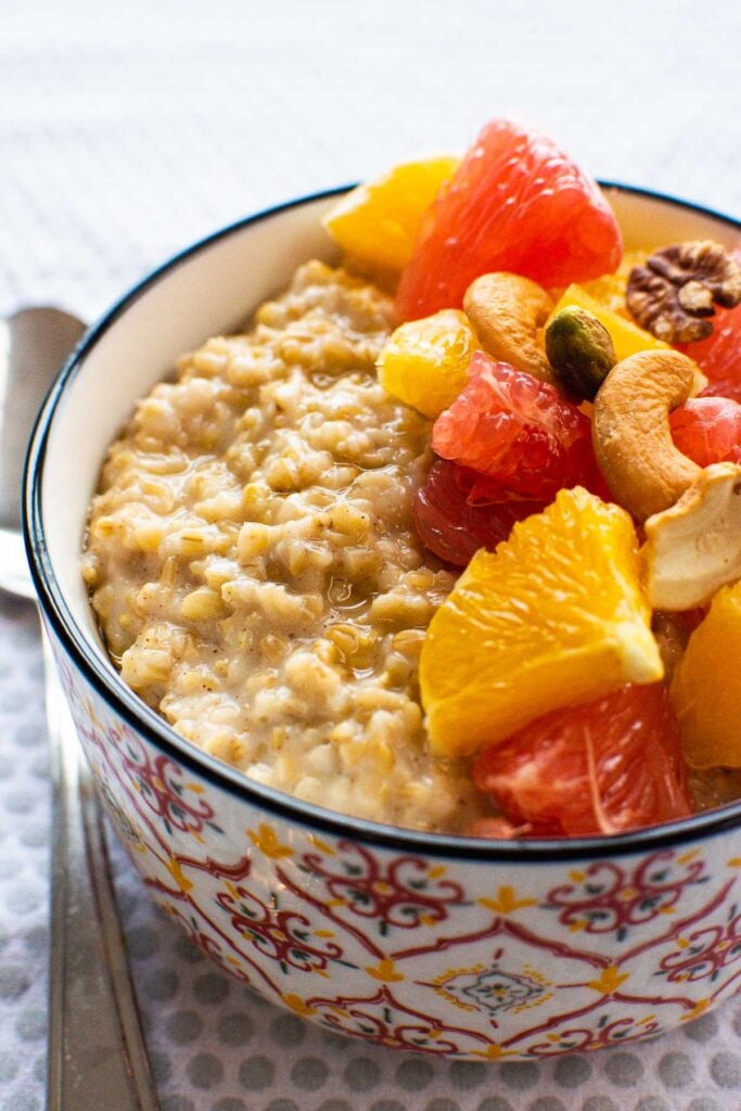 instant pot steel cut oats in a bowl with citrus fruit and nuts