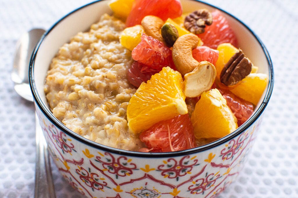steel cut oatmeal instant pot in a bowl with fruit and nuts