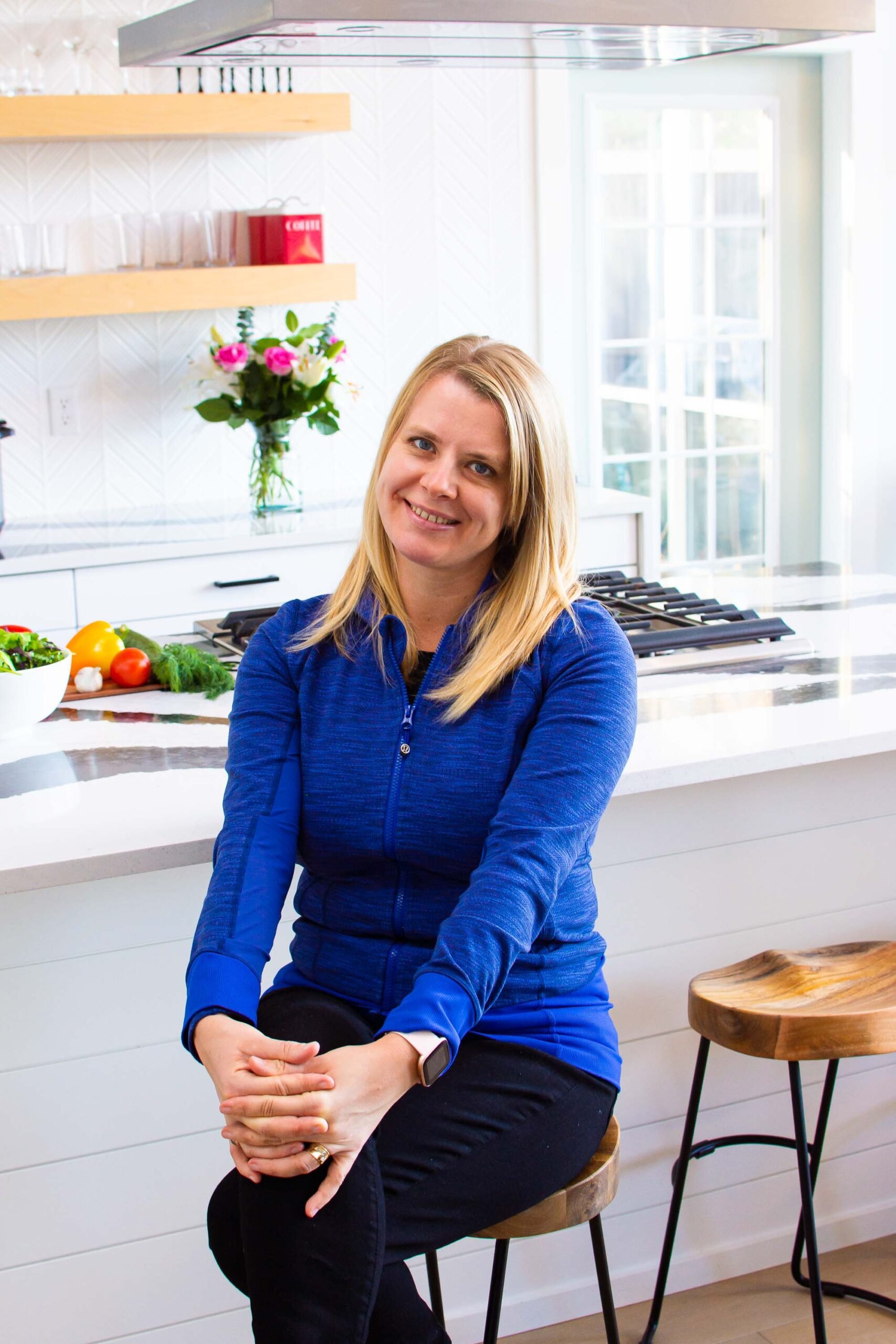 Olena osipov sitting on a stool in ifoodreal kitchen.