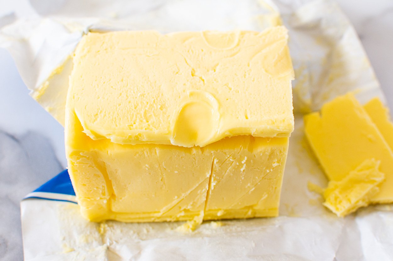 Softened butter with finger indent in to show softness.