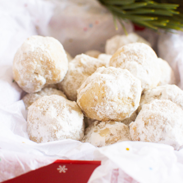 healthy snowball cookies in a holiday box with a touch of greenery