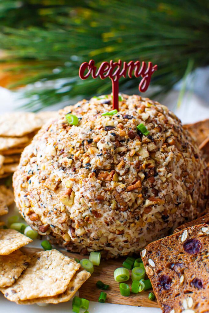 healthy cheese ball recipe on a party platter with green onion and crackers