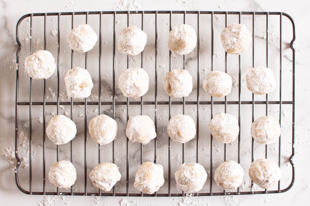 baking rack full of almond flour snowball cookies