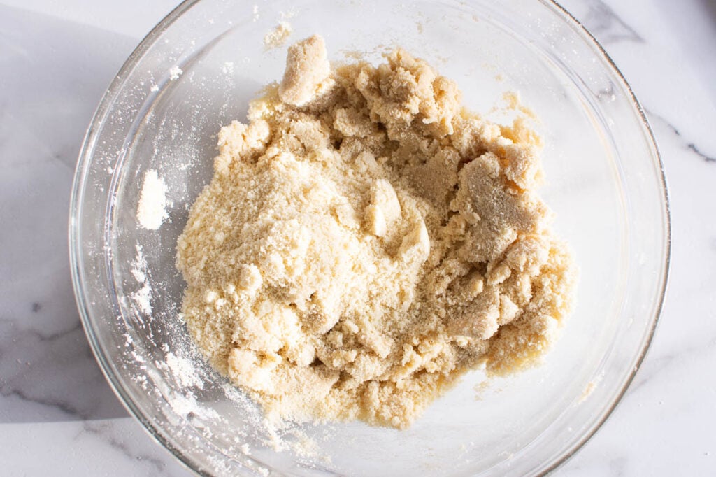 almond flour being added to snowball cookies