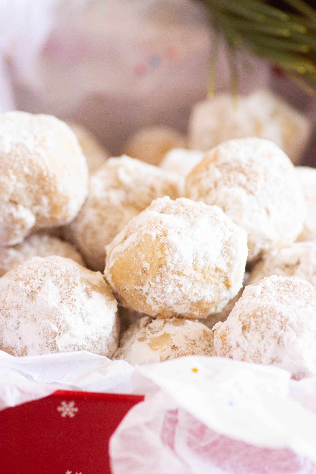 healthy snowball cookies in a box for gifting with some greenery