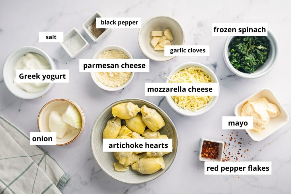 Artichoke hearts, frozen spinach, mayo, cheese, and greek yogurt ingredients.