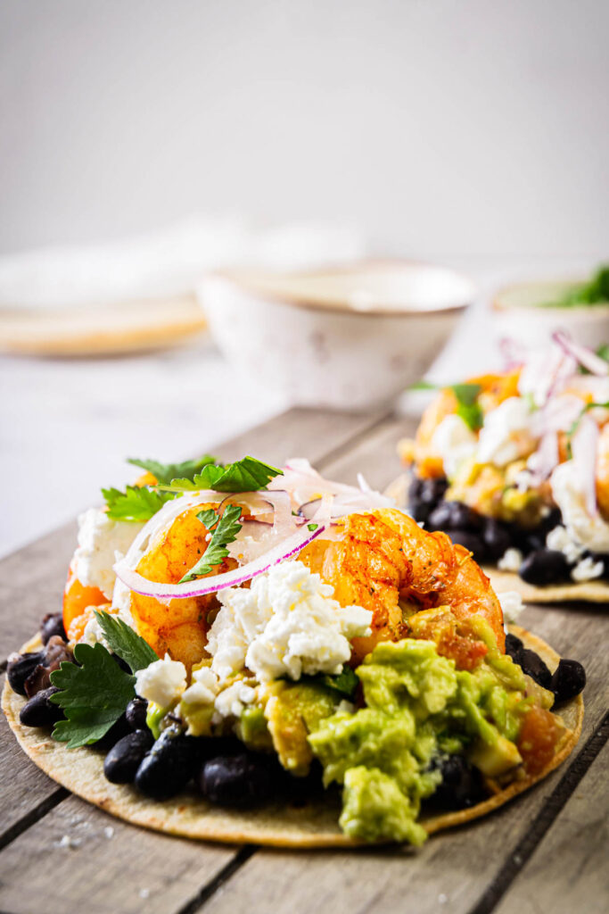 shrimp tostadas topped with guacamole salsa and cheese