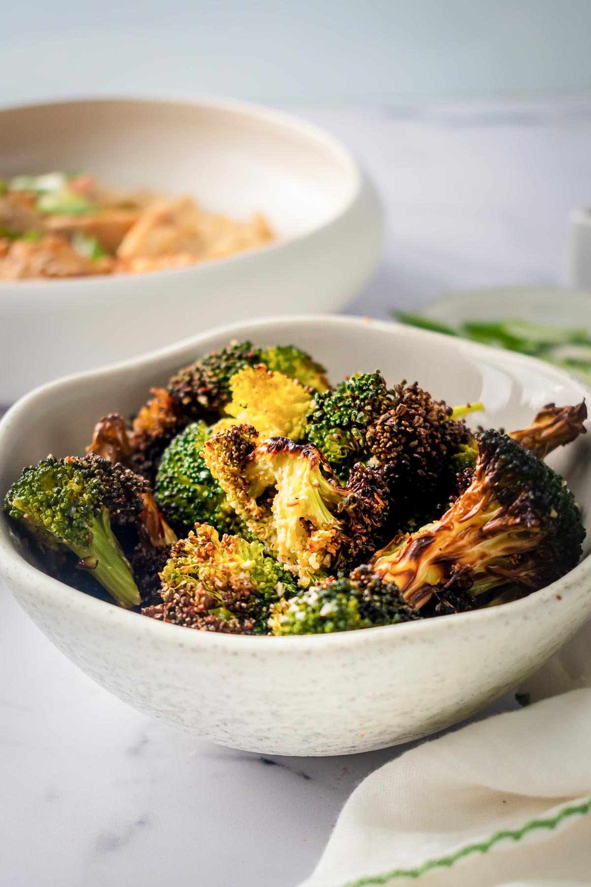 Air fried broccoli in white bowl.