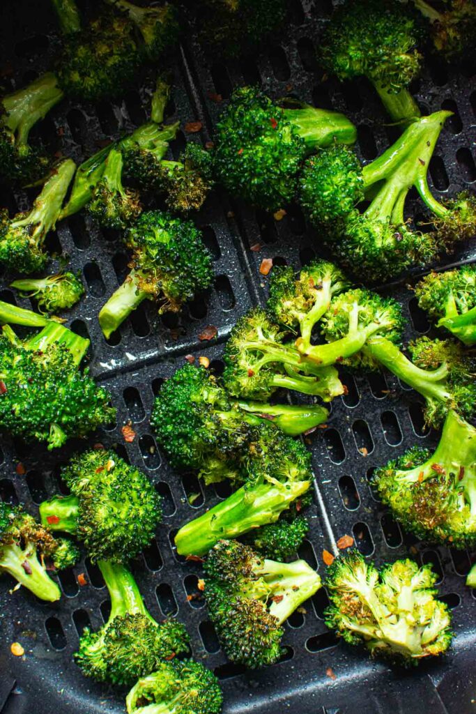 air fryer broccoli garnished with red pepper flakes