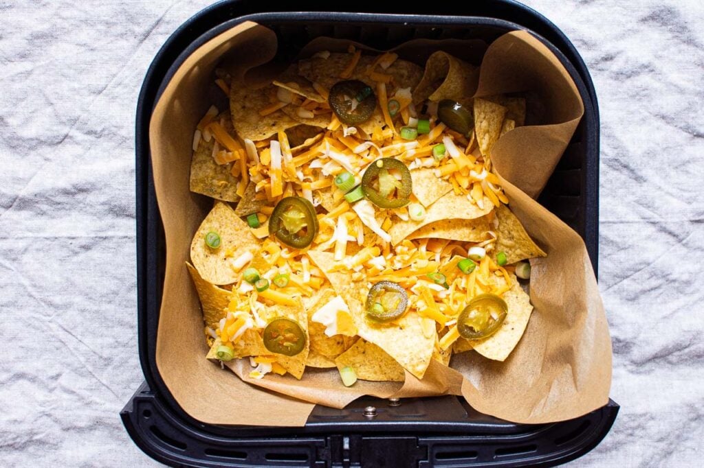 Tortilla chips layered with cheese and jalapenos.