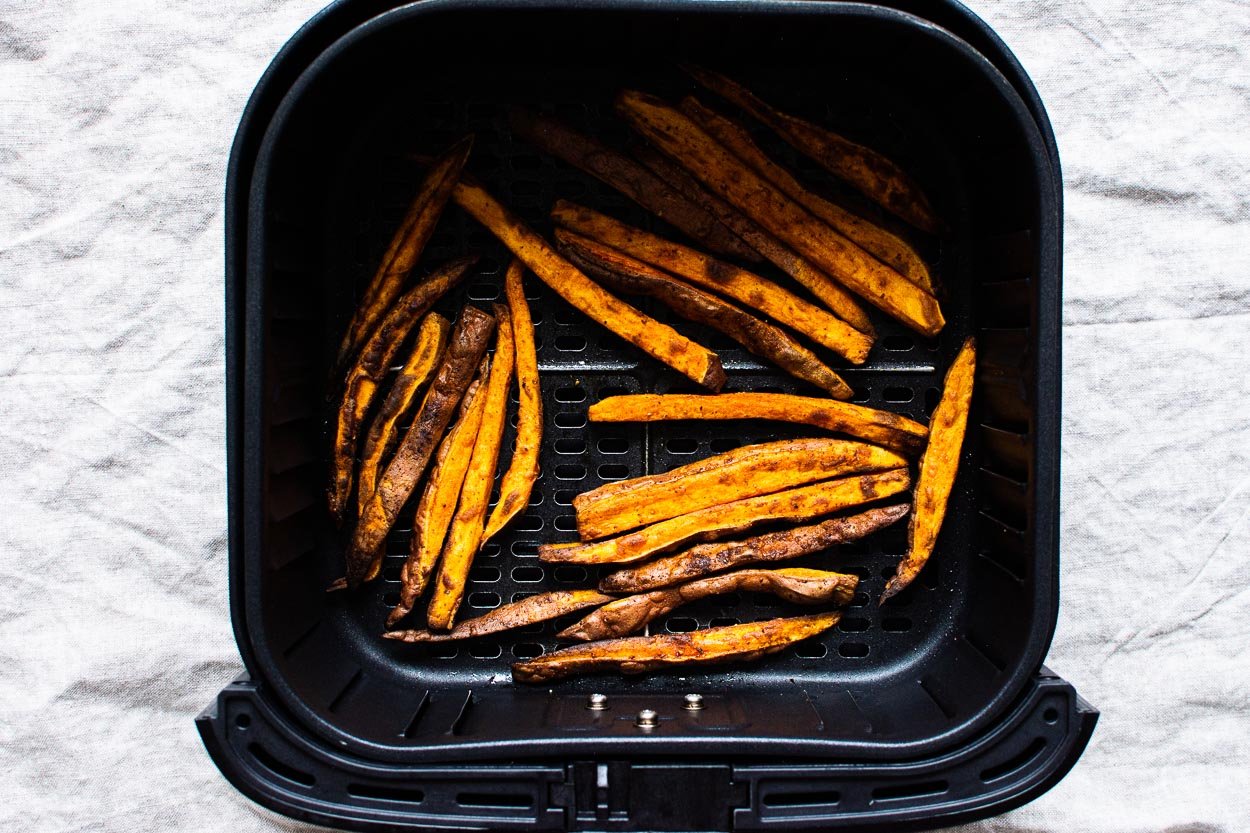 Cooked fries in the air fryer basket.