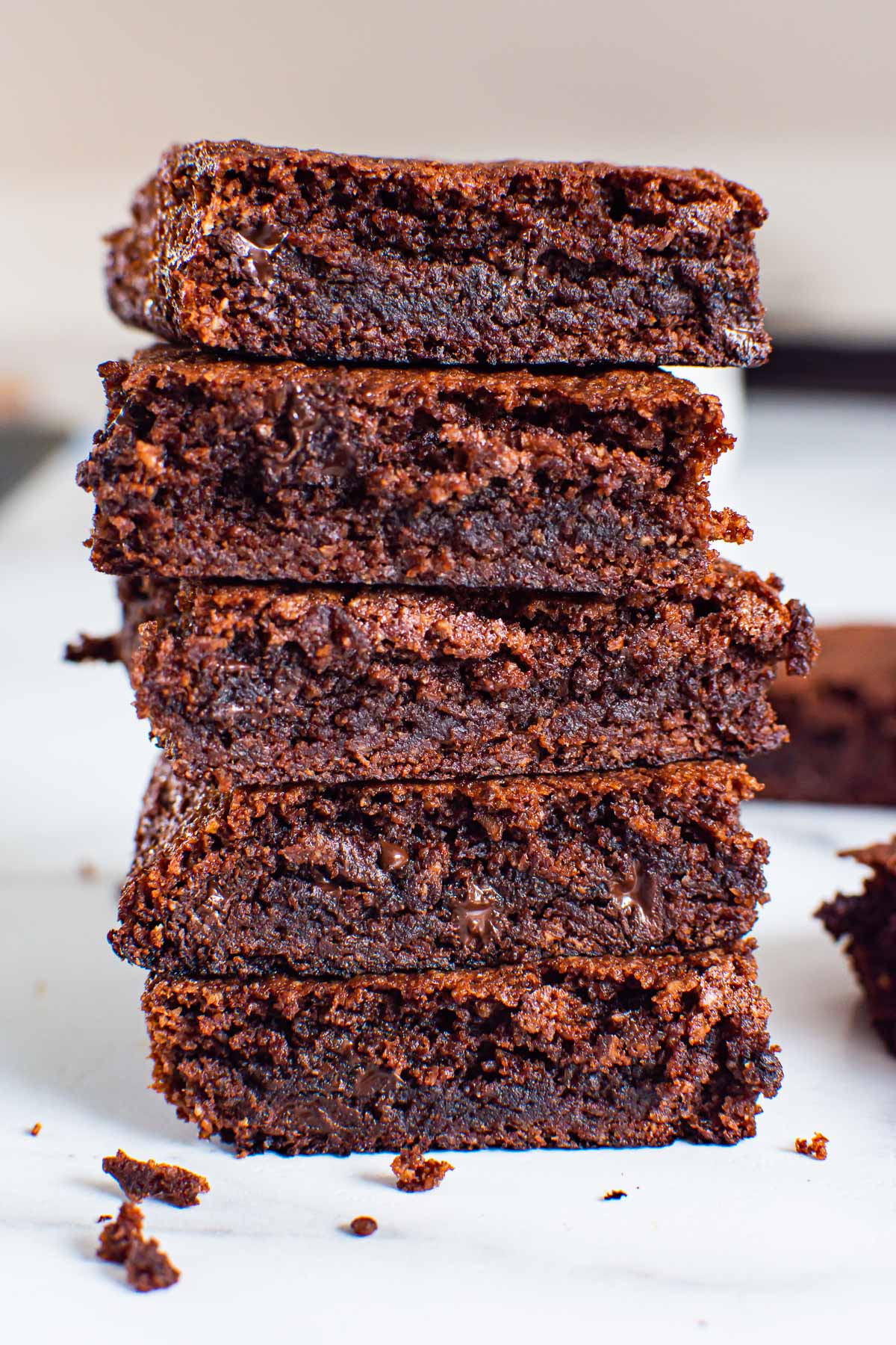 Five almond flour brownies stacked.