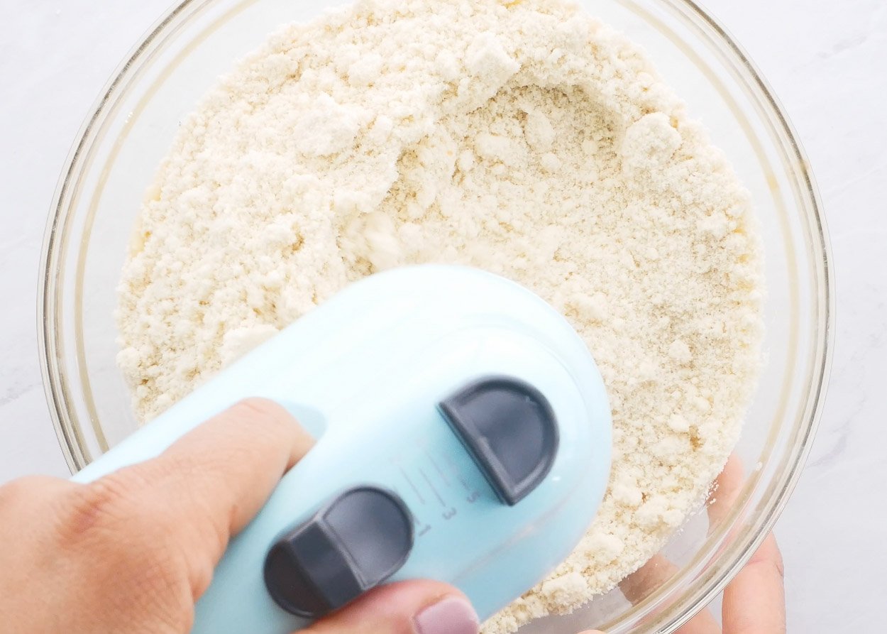 Mixing in almond flour with electric mixer. 
