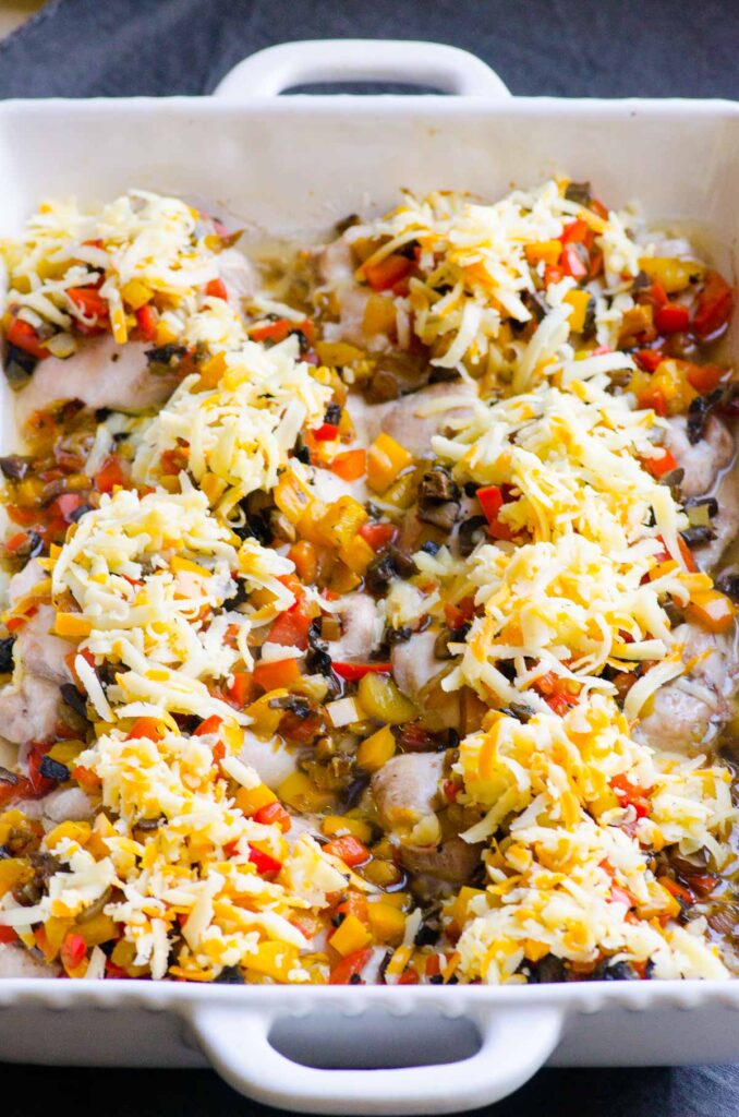 Chicken topped with peppers and cheese.