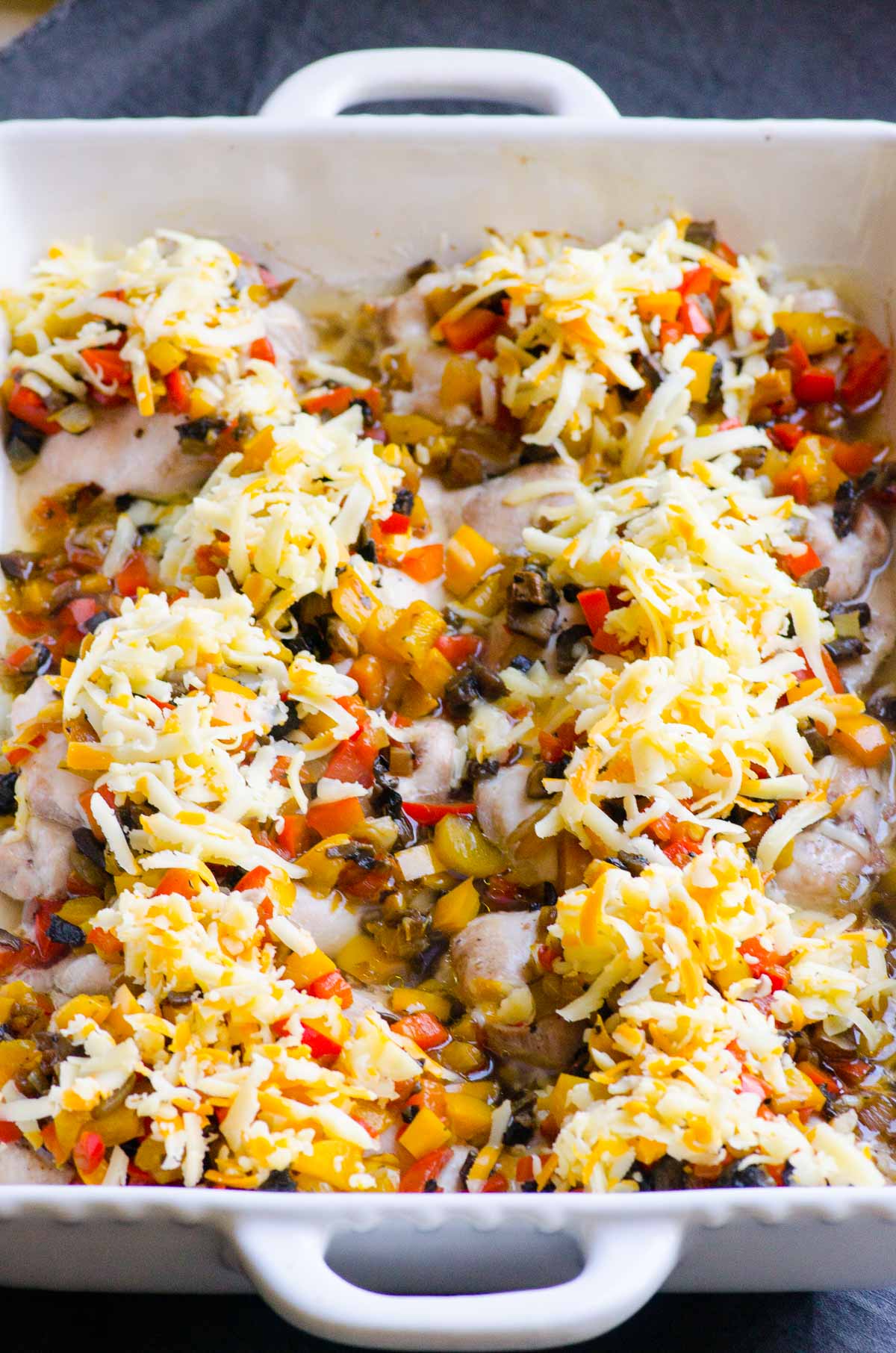 Chicken baked and topped with sauteed veggies and shredded cheese.
