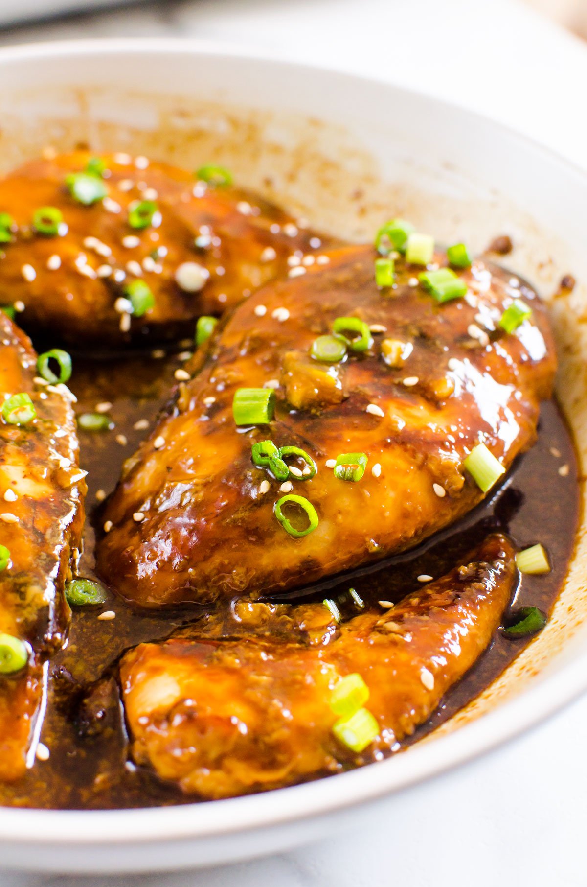 Honey chicken breast recipe with healthy soy garlic sauce in baking dish.