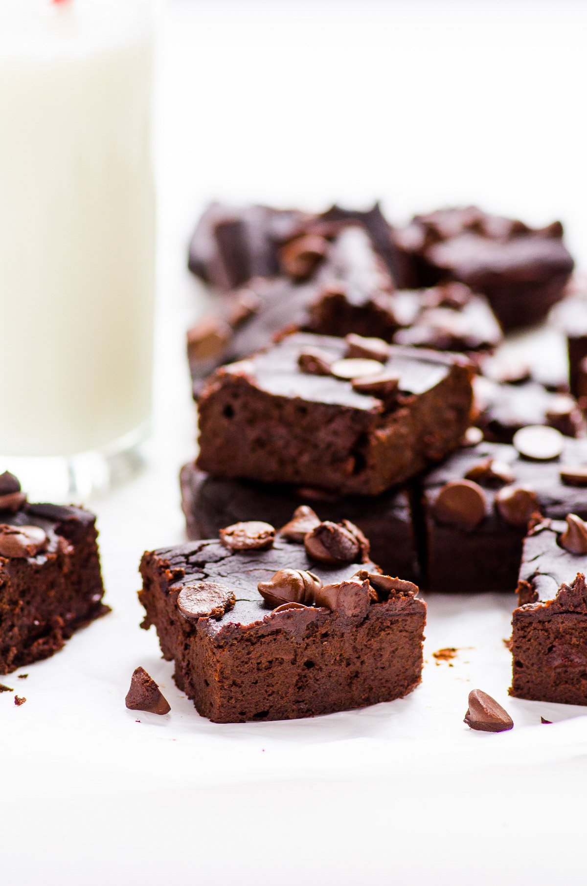 Black bean brownies cut into squares topped with chocolate chips.