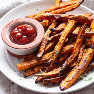 air fryer sweet potato fries on a plate with ketchup