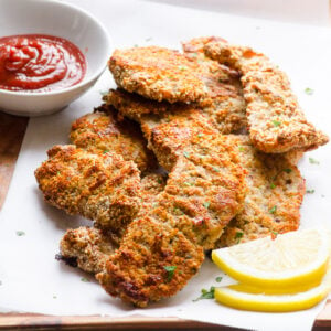 almond flour chicken tenders on a plate with ketchup
