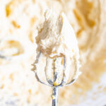 Healthy buttercream frosting on a mixer beater.