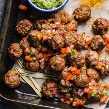 mexican meatball recipe on a serving with toothpicks and guac