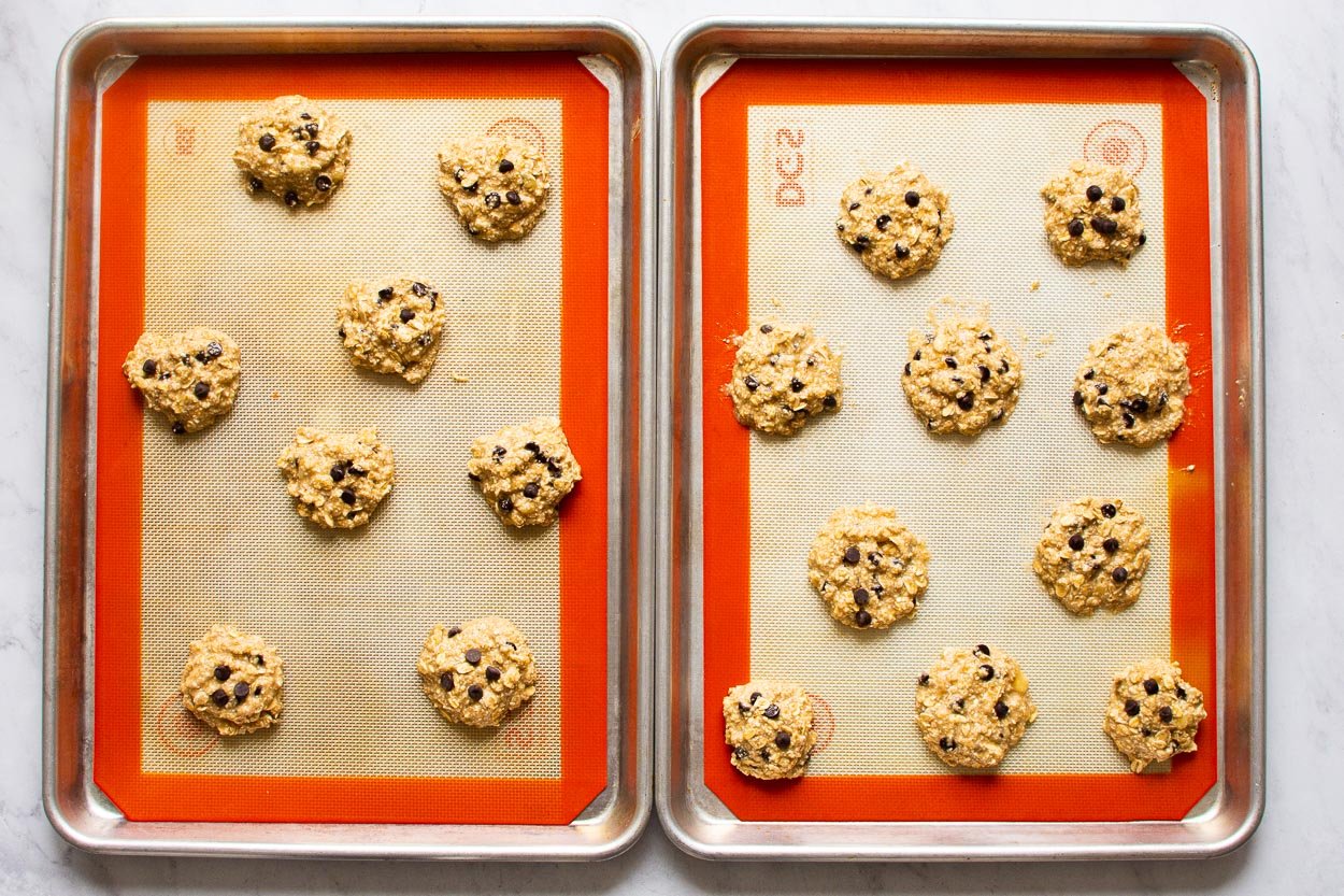 Unbaked cookie dough on two silpat lined baked sheets.