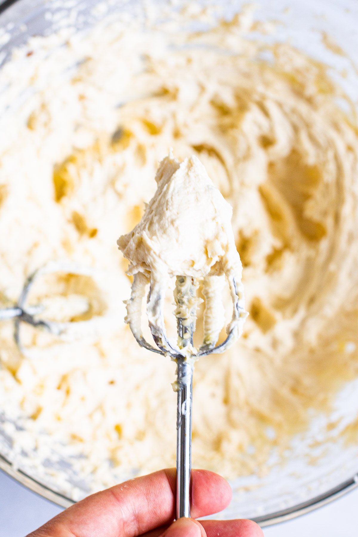 Healthy buttercream frosting on a mixer beater.