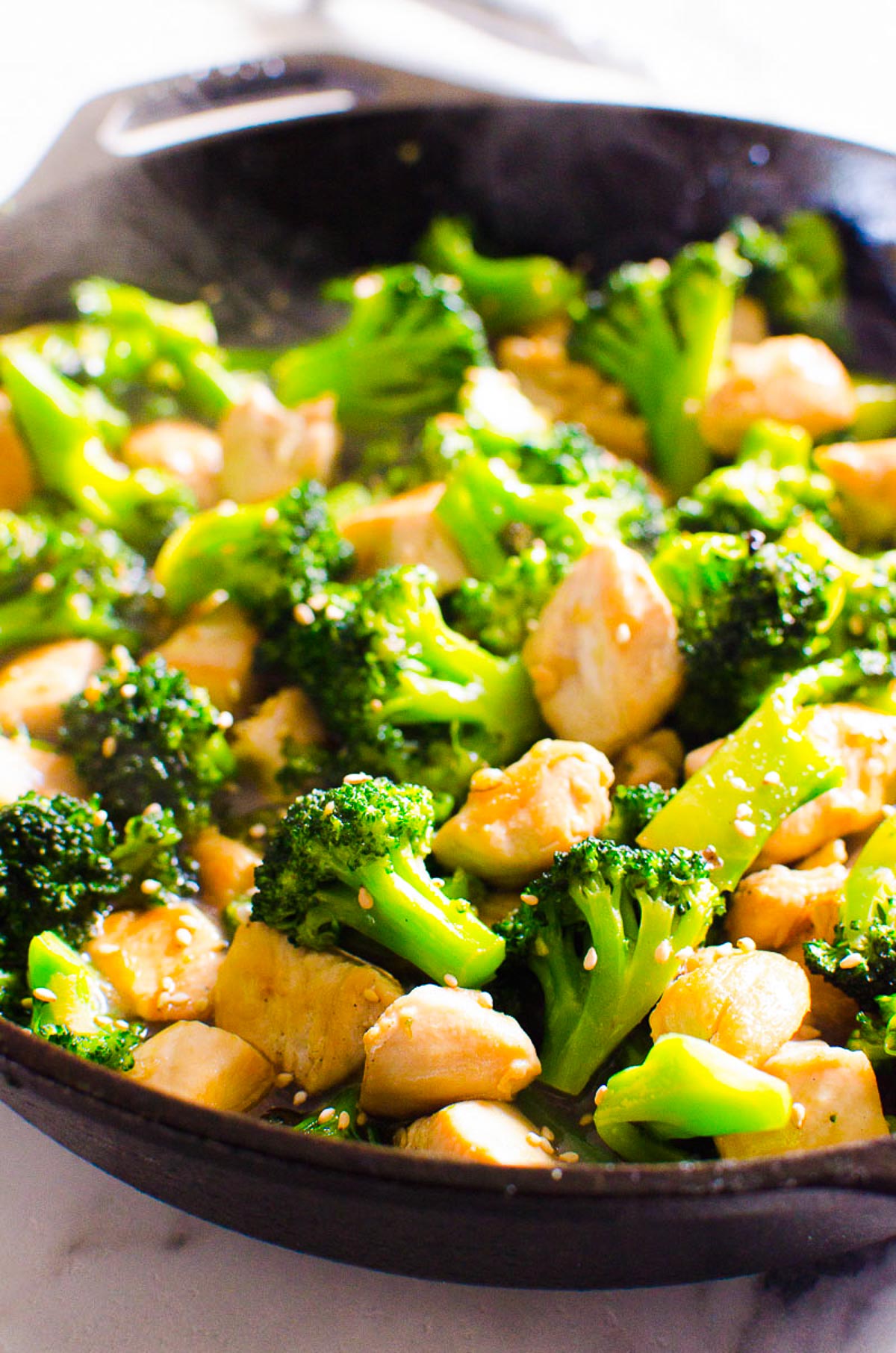 Chinese chicken broccoli stir fry in cast iron skillet.