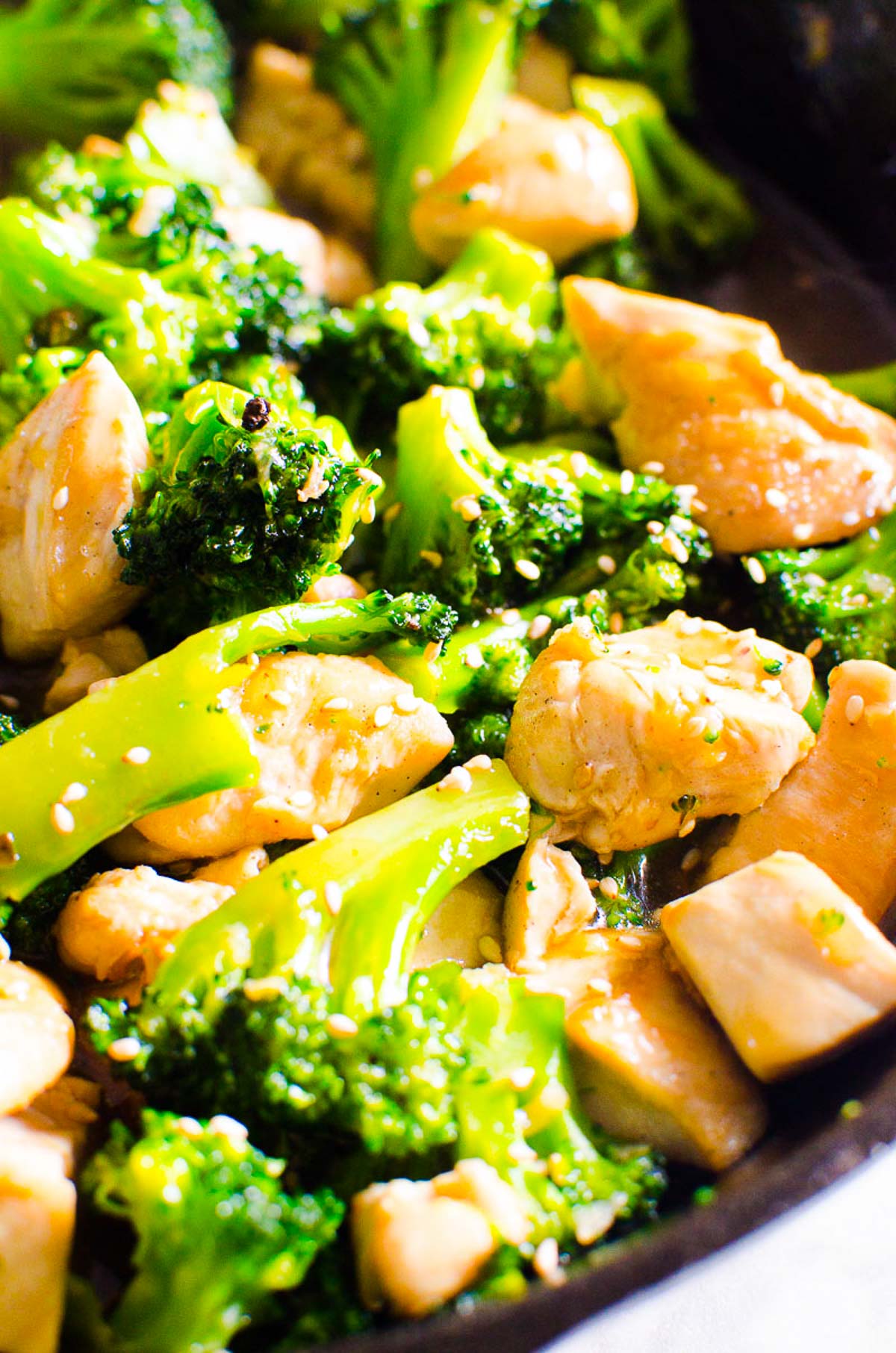 Chicken broccoli stir fry garnished with sesame seeds.