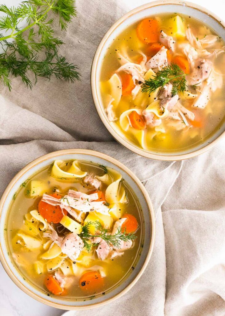two bowls of healthy chicken noodle soup