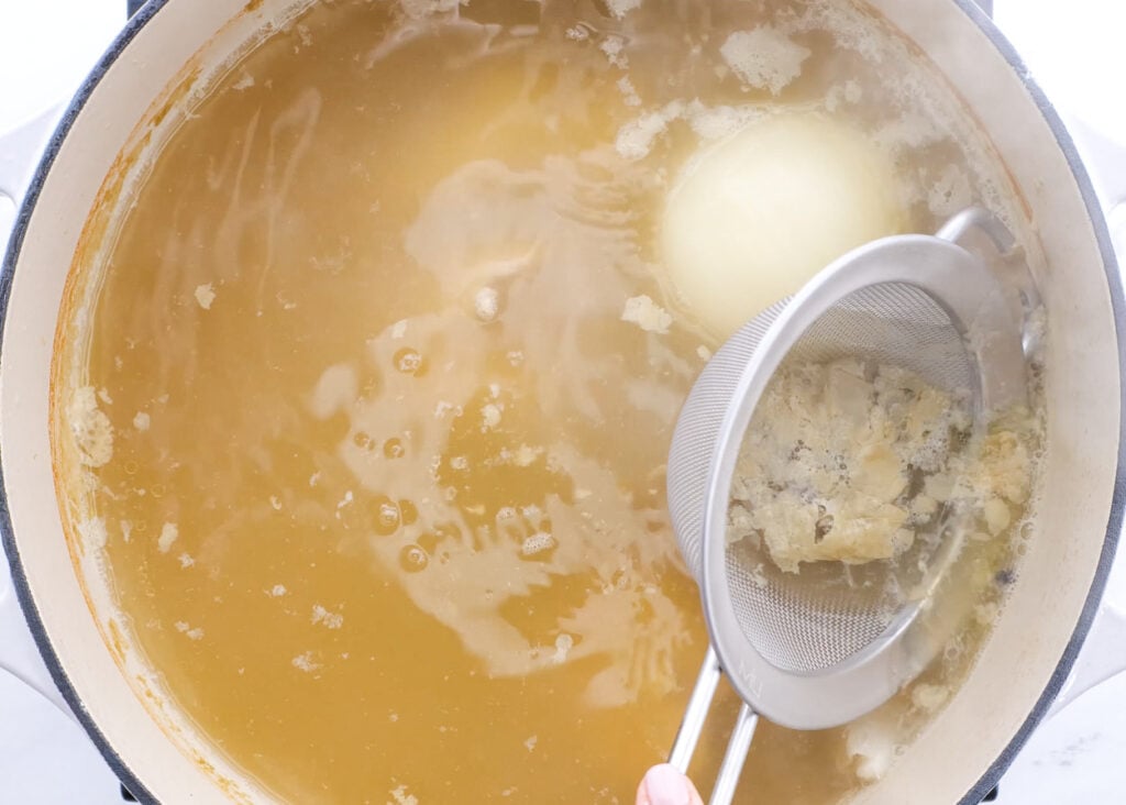 removing foam from homestyle chicken soup while boiling