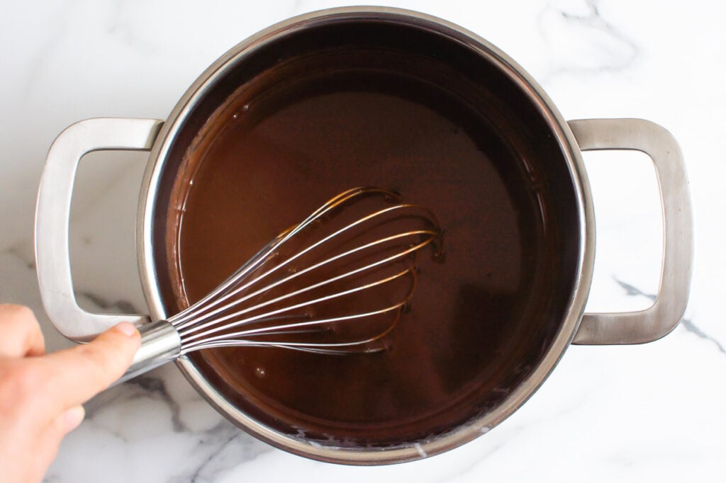 Whisking chocolate and coconut milk in sauce pan. 