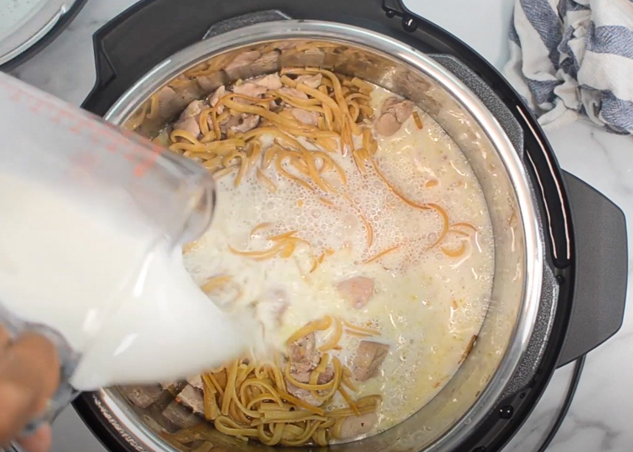 Pouring milk into Instant Pot.