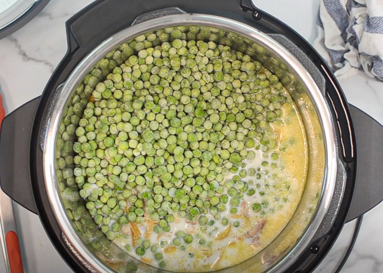 Adding peas to Instant Pot. 