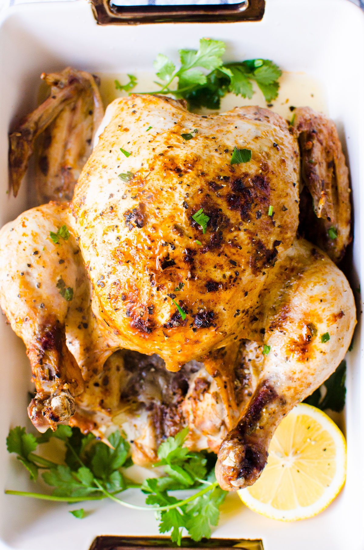 instant pot whole chicken roasted and ready to serve on platter with garnish