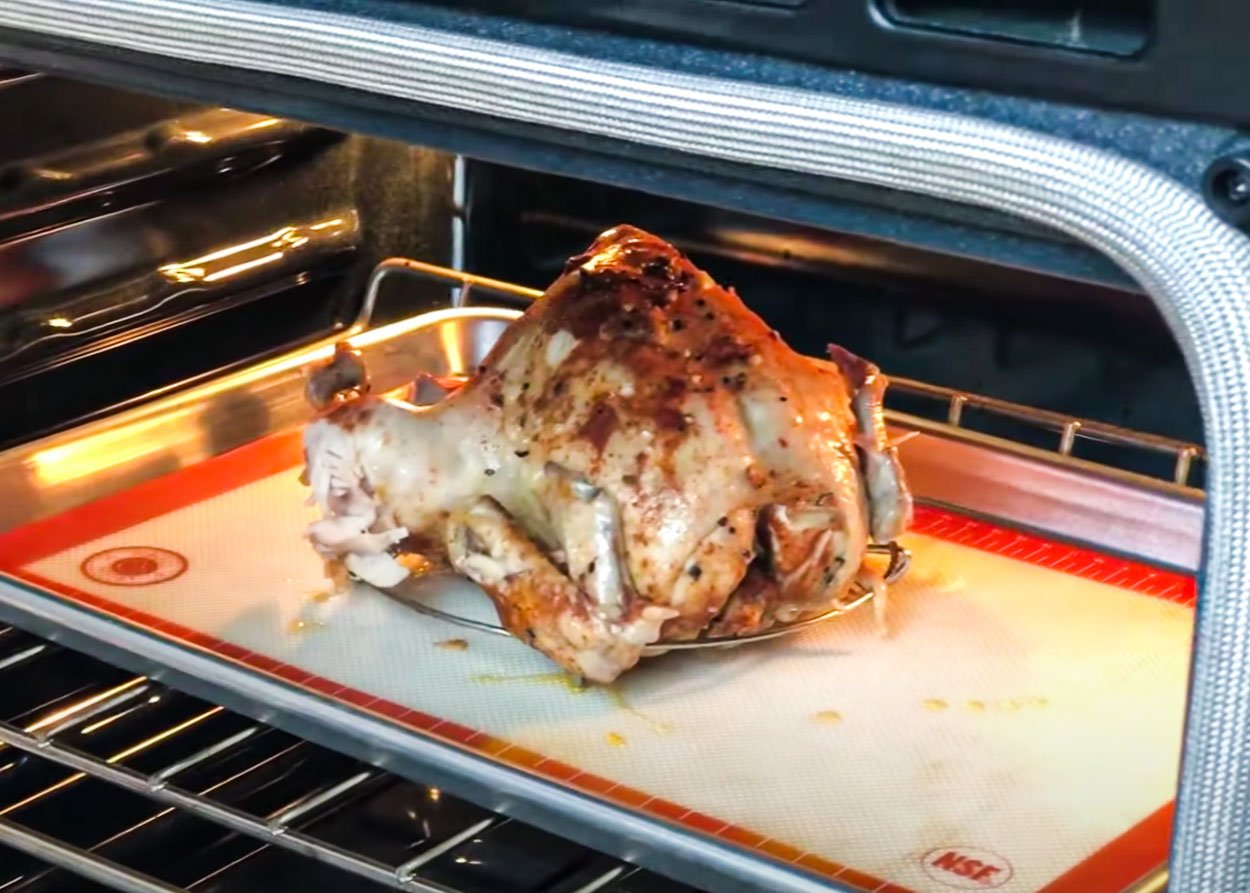 Broiling skin of instant pot whole chicken on a baking sheet inside the oven.