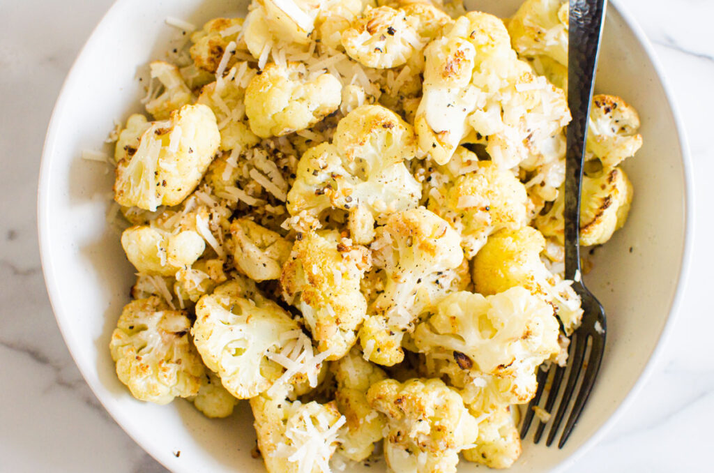 roasted cauliflower with parmesan and garlic in a bowl