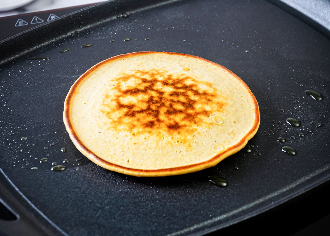 Cooked pancake on griddle.