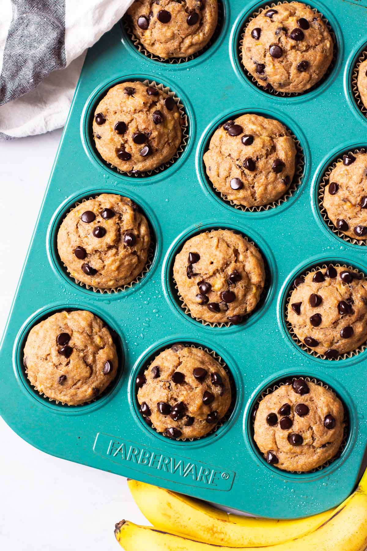 Healthy banana chocolate chip muffins in a blue muffin tin.