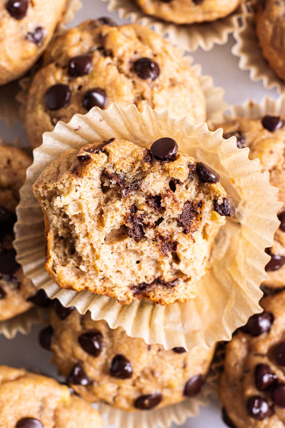 Healthy banana chocolate chip muffin with a bite taken out of.