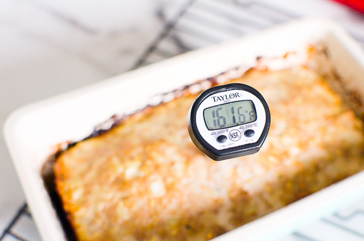 thermometer inserted in the meatloaf showing 161 degrees F
