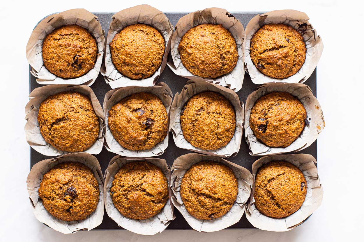 Muffins with bran baked and cooling in pan.