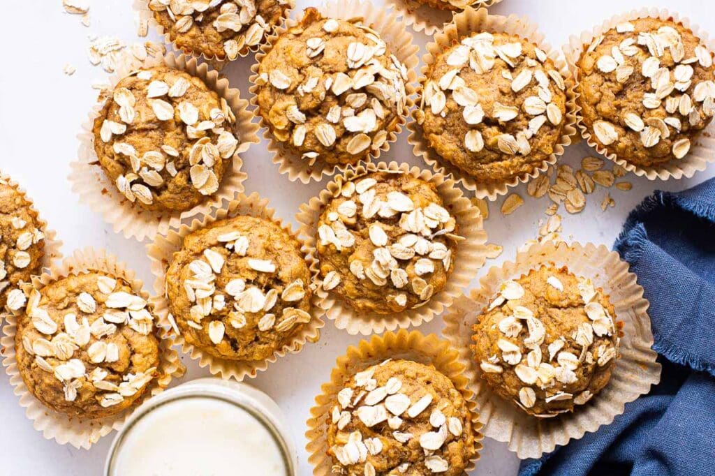 oatmeal muffins with a glass of milk and blue linen napkin