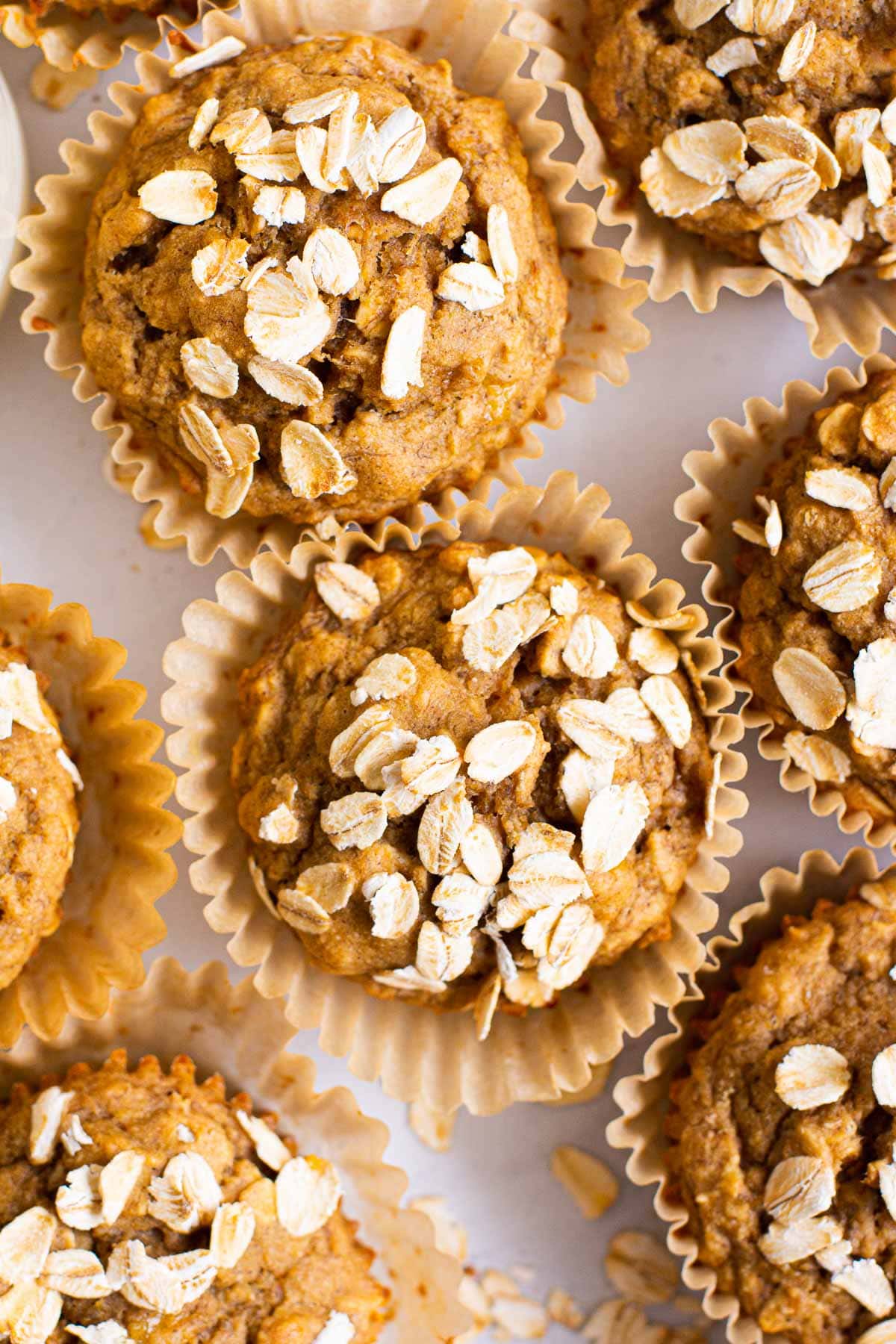 baked oatmeal cups in muffin liners topped with oats