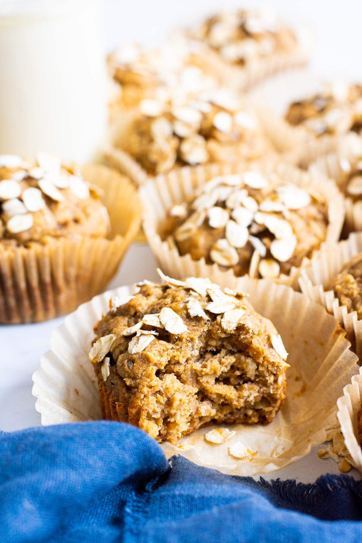 healthy oatmeal muffins with oats on top and a blue linen