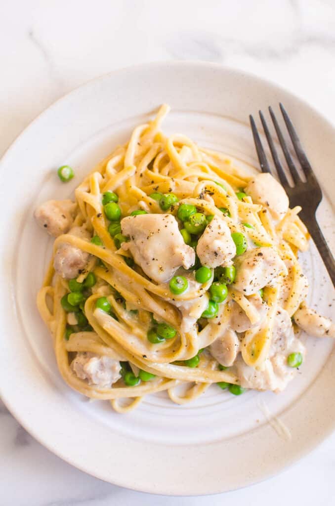 Pasta on plate with chicken and noodles.