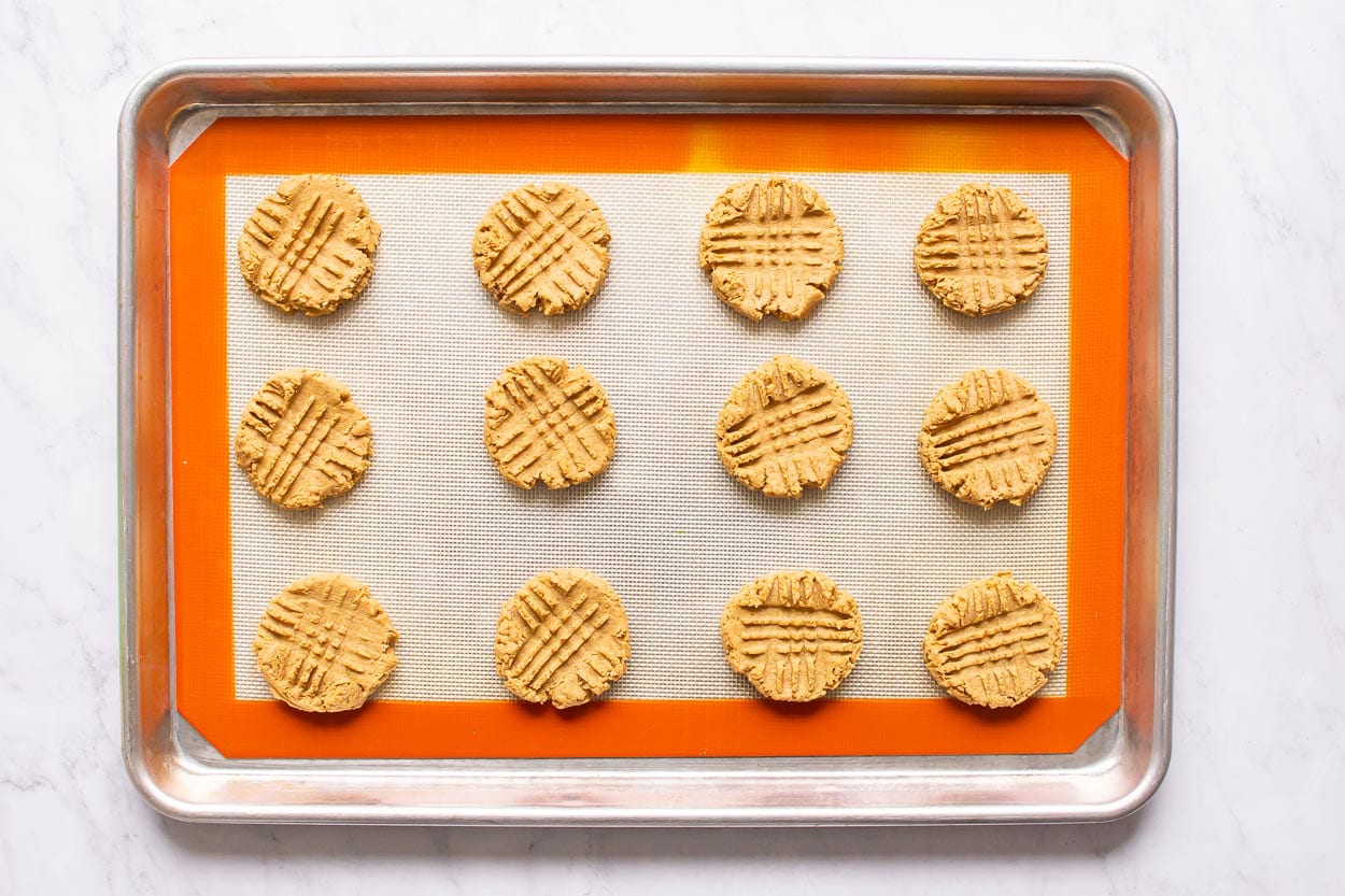 Baked and cooled healthy peanut butter cookies on baking sheet.